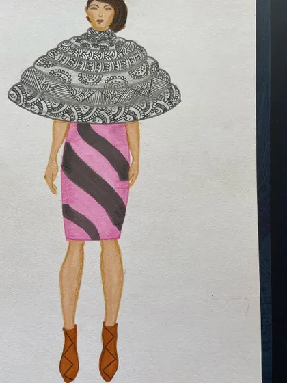 A design featuring a large, patterned capelet over a striped pencil skirt.