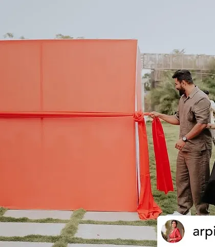 The anticipation builds. The setup for our car unboxing reveal features a large fabric wall that can be pulled away in a single, dramatic motion.