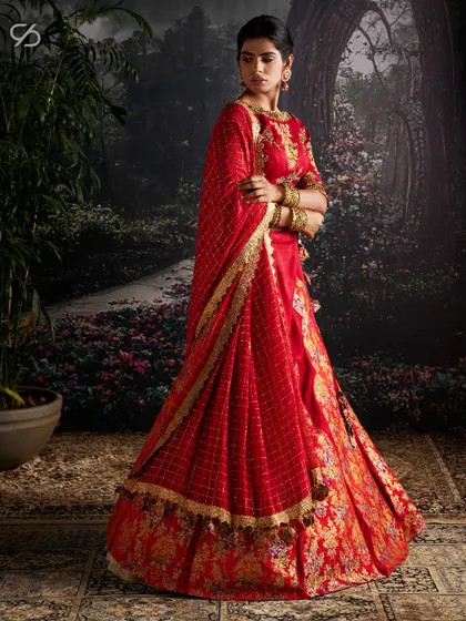 I believe in creating exclusive pieces for your special day. This red bridal lehenga features glimmering Swarovski crystals, delicate 3D accents, thread embroidery, and intricate patchwork.