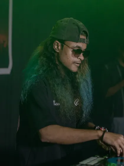 A green-lit photo of me at the decks, concentrating on the mix.
