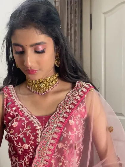 A side profile showing how the makeup and half-up hairstyle come together for a complete, polished party look.
