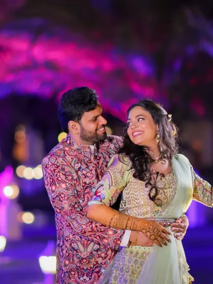 A romantic dance shot of the couple, with beautiful purple and blue lighting creating a magical mood.