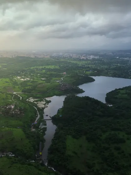 आपले कोंडेश्वर, बदलापूर. Our Kondeshwar. A wide aerial panorama showing the lake and the surrounding greenery, a popular spot for locals to escape the city.