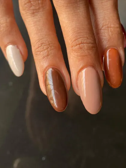 A close-up of the earthy-toned manicure, showing the different shades of brown.