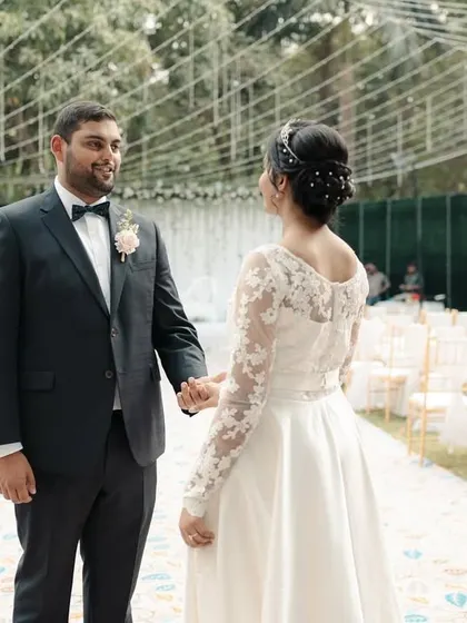 The first look. The groom sees his bride for the first time in her white wedding dress, a moment filled with emotion.
