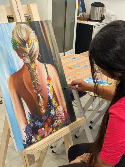 This beautiful painting of a girl with flowers in her hair showcases how we blend portraiture with floral elements. The student did a wonderful job on the soft skin tones and the texture of the braid.