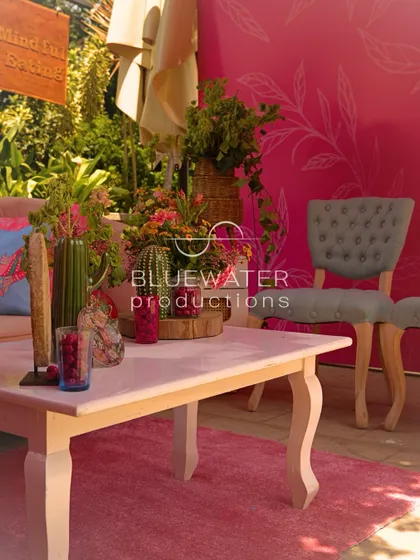 A lounge area with a bold pink backdrop, creating a vibrant and modern photo opportunity.