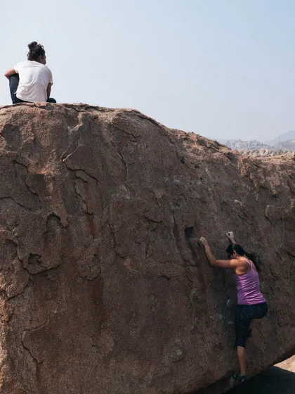 A classic Hampi scene: a massive, sun-baked boulder with climbers working on a problem. The potential for climbing here is limitless.