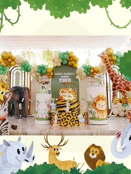 This jungle theme for a second birthday was full of adorable animal friends. The decor featured cute cartoon versions of a lion, zebra, and elephant, with a lush green and gold balloon arch to complete the safari look.