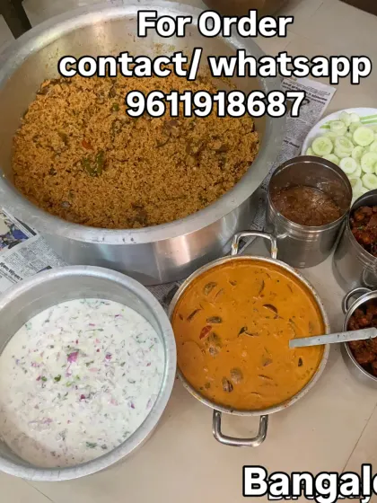 Mutton biryani, chicken kabab and raita are shown in our birthday party spread, with bread halwa packed alongside.