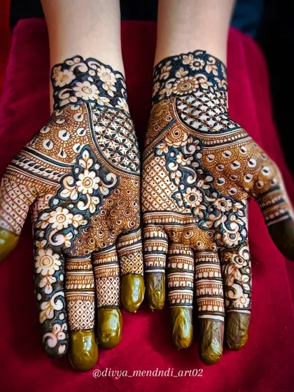 This is a reverse-fill or negative space floral design, where the background is filled with dark henna, making the flowers pop. It's a modern technique that creates a dramatic and beautiful contrast on the hands.