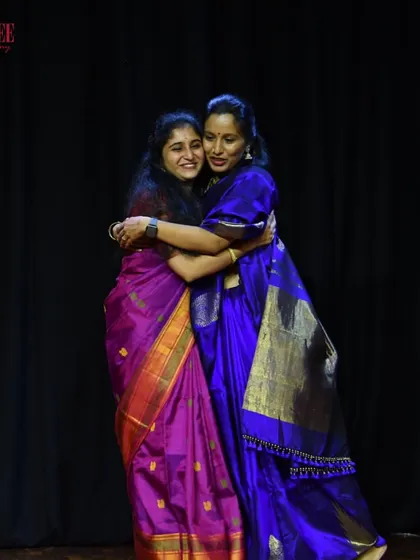 The sisterhood of dance. A hug between our team members, celebrating the success of our community event.
