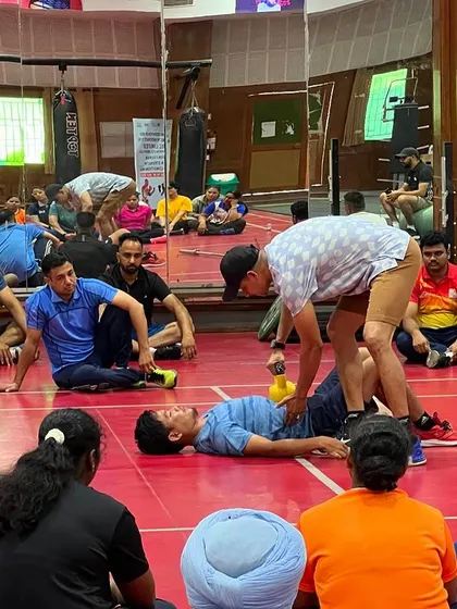 Demonstrating a technique for assessing an athlete's core function. Hands-on learning is a critical part of my coach education programs.
