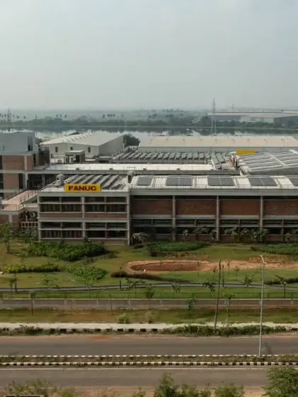 The factory design incorporates bioclimatic principles, natural materials, and green spaces to create a better working environment.