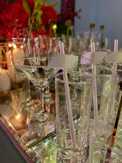 A variety of glassware, each prepared with personalized straws and stirrers, ready to be filled with our delicious cocktails.