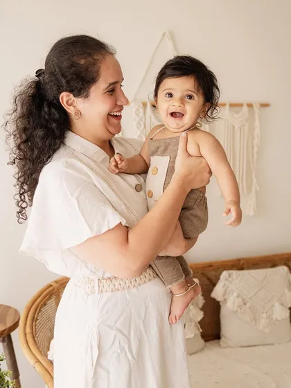 A mother's laughter with her baby. These are the candid, joyful moments that truly tell the story of your family's love.