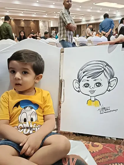 This little boy in a Donald Duck shirt was a fun subject. His caricature has a sweet, gentle feel.