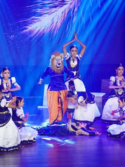 A dramatic scene from "SREEMAN NARAYAN" depicting the story of Lord Narasimha. The use of masks and costumes brings the mythological tale to life.