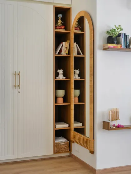 This simple PU-polished wardrobe from 'House of Kismish' is elevated by a beautiful arched, bamboo-framed mirror, adding a touch of natural warmth and elegance.