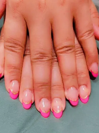 A modern take on the French manicure using a vibrant hot pink for the tips on almond-shaped nails. I added a fine gold glitter line to separate the pink from the natural base, giving it a sharp and stylish finish.