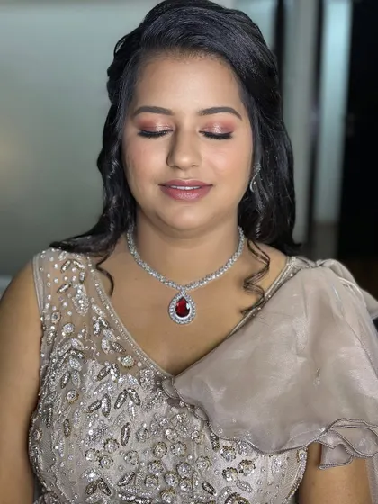 A lovely engagement look for Puja, with soft pink makeup that complements her beautiful smile.