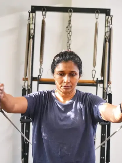 Focus and determination are key in Pilates. This exercise on the Cadillac strengthens the upper back and shoulders, which is crucial for maintaining good posture.