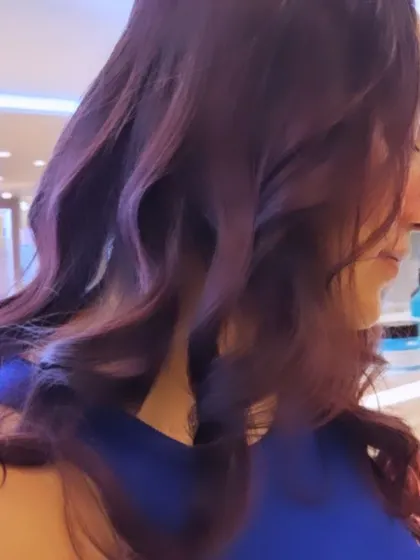 The side profile of this stunning magenta transformation. The color is rich and even from root to tip, a testament to a professional coloring process.