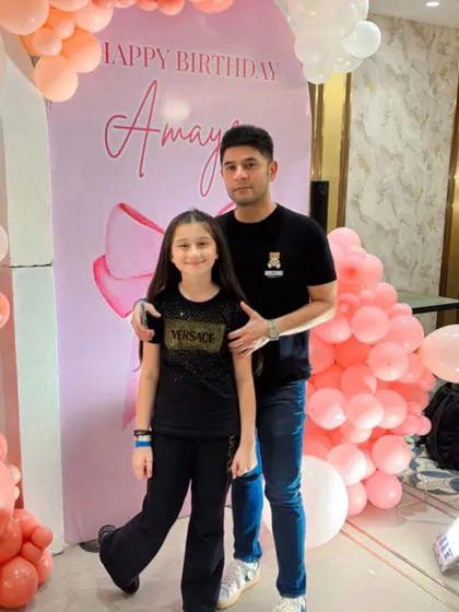 The birthday girl and her dad posing for a sweet photo.