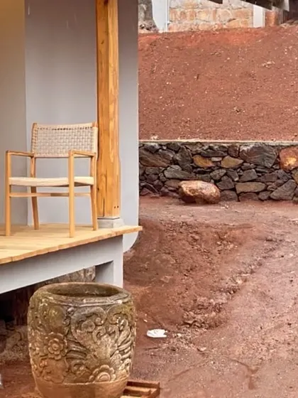 A quiet moment on the construction site at TARA. A lone chair on an unfinished veranda hints at the future tranquility of the space.