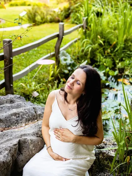 A solo portrait of the mama-to-be, finding a moment of peace during our outdoor session. It's so important to capture these feelings of calm and connection with your baby bump.