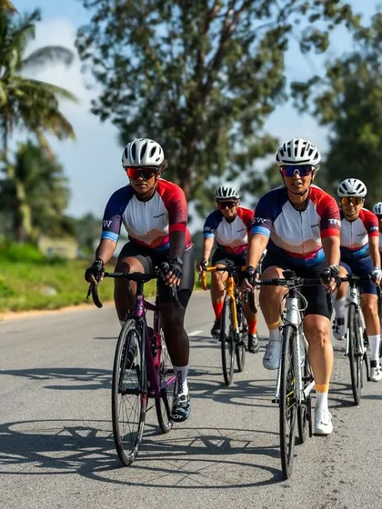 All smiles on two wheels. A front view of our Spokies enjoying a sunny group ride, showcasing the joy and energy of our cycling community.