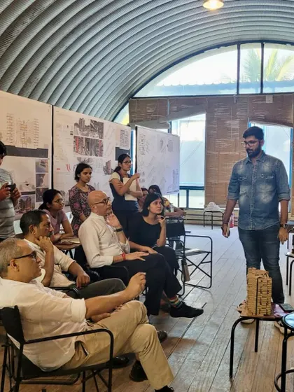A wide view of a design review in progress. The studio environment is a forum for ideas, where students, mentors, and guest critics come together to discuss and advance the work.