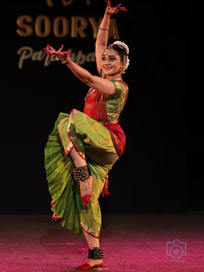 A powerful leg extension, showcasing the strength and flexibility required in this classical dance form.