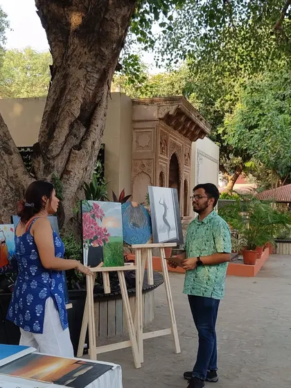 Talking to a visitor at my stall during the Aham Festival. These conversations are the best part of showcasing my work. I get to share the stories behind the paintings, and hear how they resonate with others.