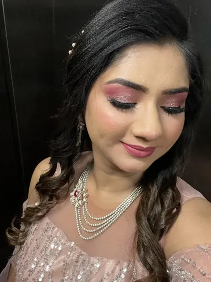 Eyes closed to show off the stunning pink glitter cut-crease. This is a great way to add glamour to your party look.