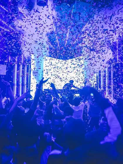 A blue-lit confetti drop at the Flo Finale. The lighting and effects are timed perfectly with the music to create peak moments throughout the night.