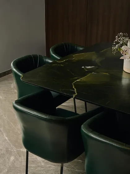 I believe in using materials that make a statement. This dining table is crafted from a rare Brazilian Avocatus Green Quartzite with a leathered finish, creating an earthy yet luxurious centerpiece. The stone's natural durability ensures it is as practical as it is beautiful.