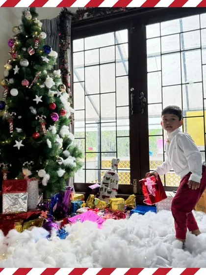 A child discovers the presents under the Christmas tree. The wonder and excitement of the holiday season are captured in this moment.
