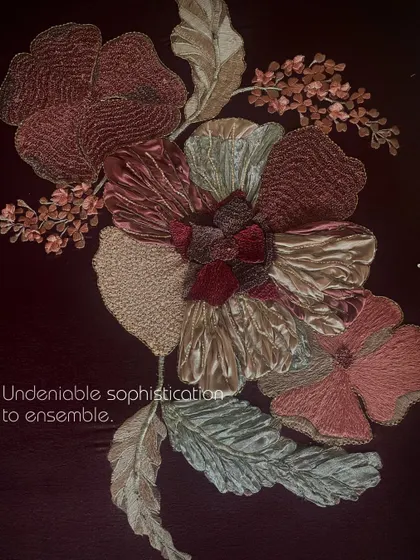 A close-up of the undeniable sophistication of the 3D floral embroidery on the brown suede saree, showcasing a mix of fabric manipulation and beadwork.