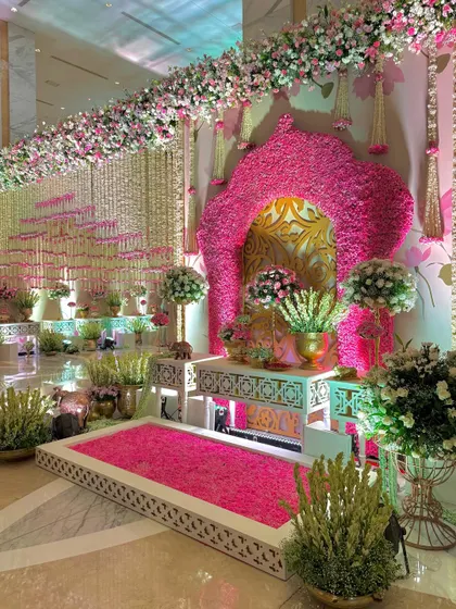 A wider angle of the photo corner, showing how it integrates into the larger space with floral garlands and a cascading wall of flowers.