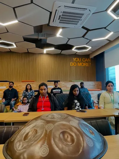 A handpan sits in the foreground during a corporate wellness session at Ninjacart. Its presence alone brings a sense of calm and curiosity to the room before the music even begins.