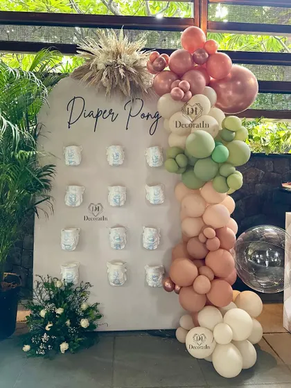 The "Diaper Pong" game is another fun and interactive activity we can set up for your baby shower.