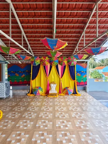A colorful Mehendi or Haldi setup with traditional Rajasthani umbrellas and bright drapes.