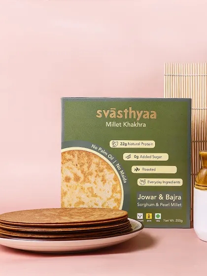 A minimalist and modern setup for Jowar & Bajra Millet Khakhra. The clean lines and simple props highlight the product's healthy, no fuss appeal.