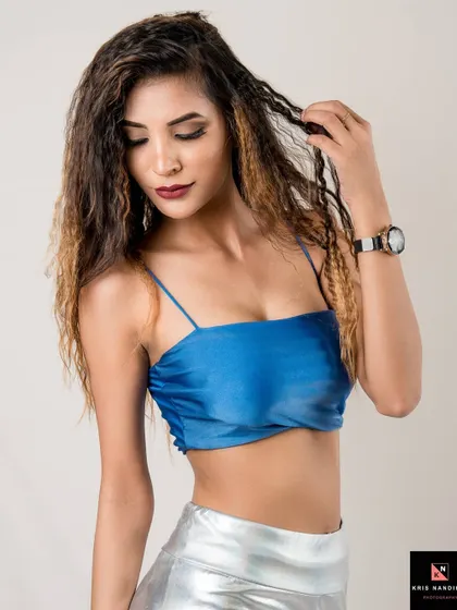 A close-up shot of the 'Lady in Satin' look. The focus is on the model's expression and crimped hair, adding texture and attitude to the portrait.