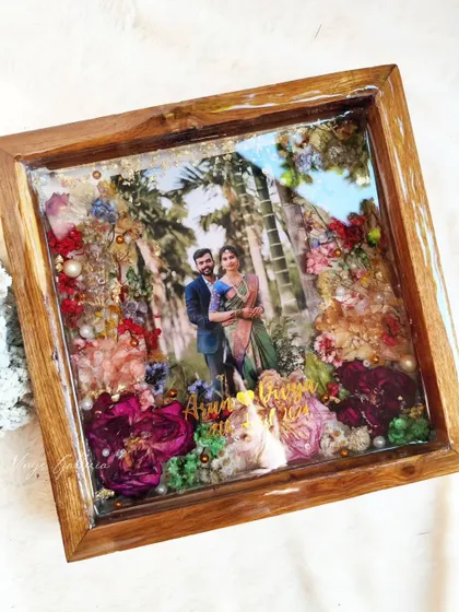 I call this frame the "Garden of Love." It's a floating wooden frame with bright roses and wild daisies, created as a special gift for a newlywed couple.
