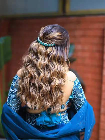 A back view of beautiful, defined curls. This half updo is a great way to show off hair color and texture.