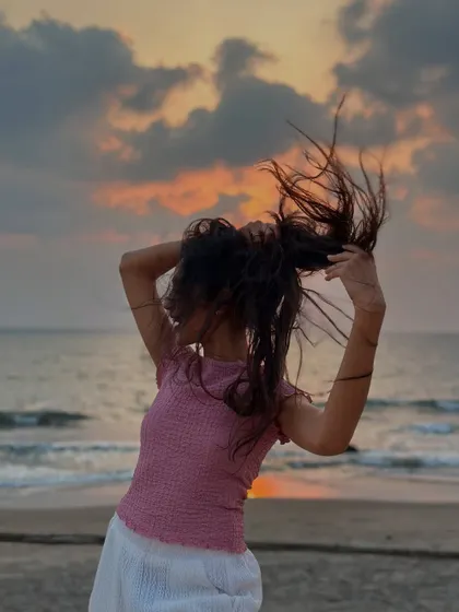 A playful, windswept hair moment on the beach at dusk. It's all about embracing the fun, carefree side of yourself.