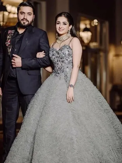 A grey ruffled or textured gown is a unique and high-fashion choice. I can design a similar statement piece for a bride who wants something different.
