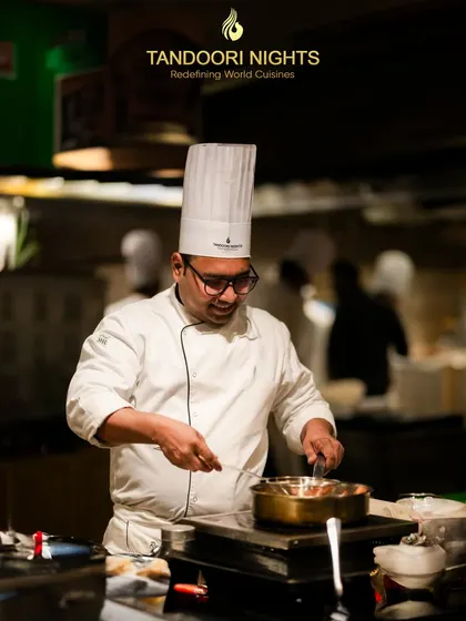 A master of flavors at work. One of our senior chefs meticulously prepares a dish, showcasing the expertise that defines our kitchen.